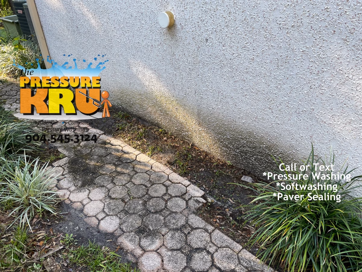 Soft wash coquina exterior in Orange Park Country Club before preserving natural stone finish