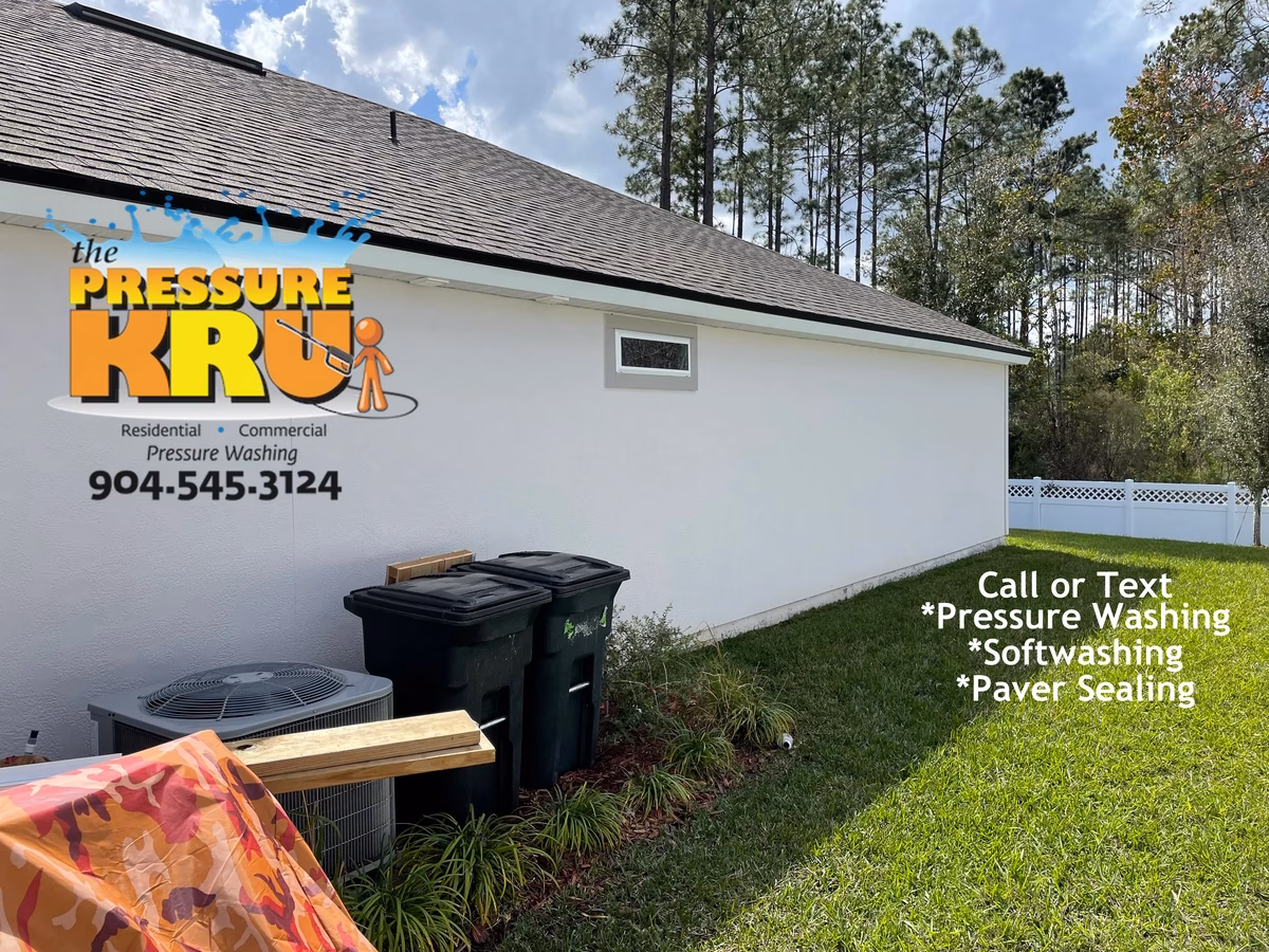 Professional house washing service removing algae from siding and vinyl soffits in Whitmore Oaks neighborhood.