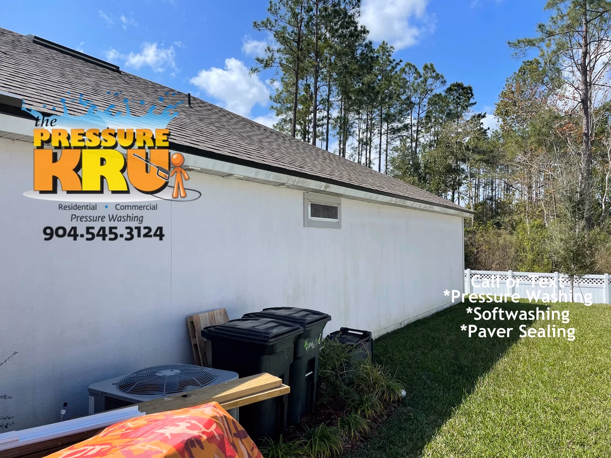 Professional house washing service removing algae from siding and vinyl soffits in Whitmore Oaks neighborhood.