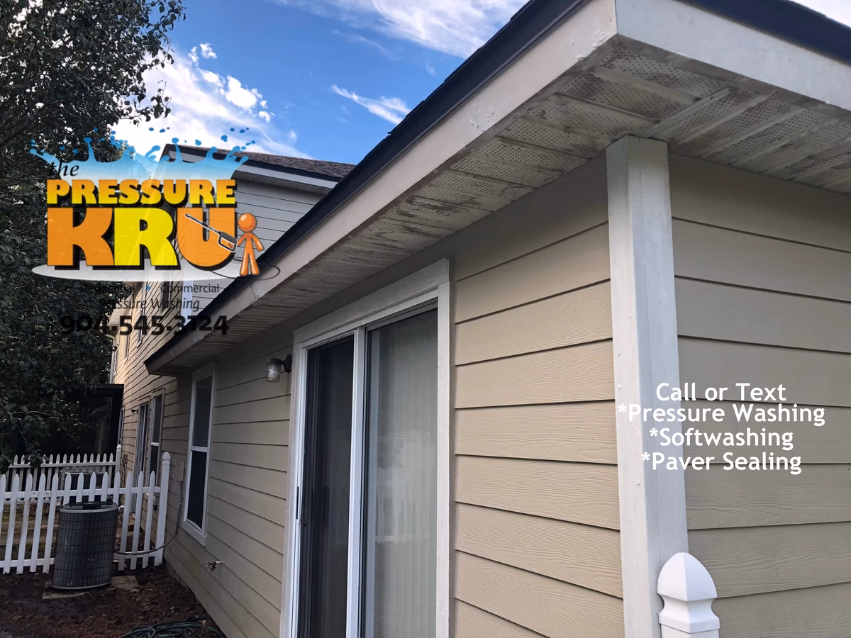 Professional house washing removes algae from siding and vinyl soffits in Southbridge Julington Creek Town home development.