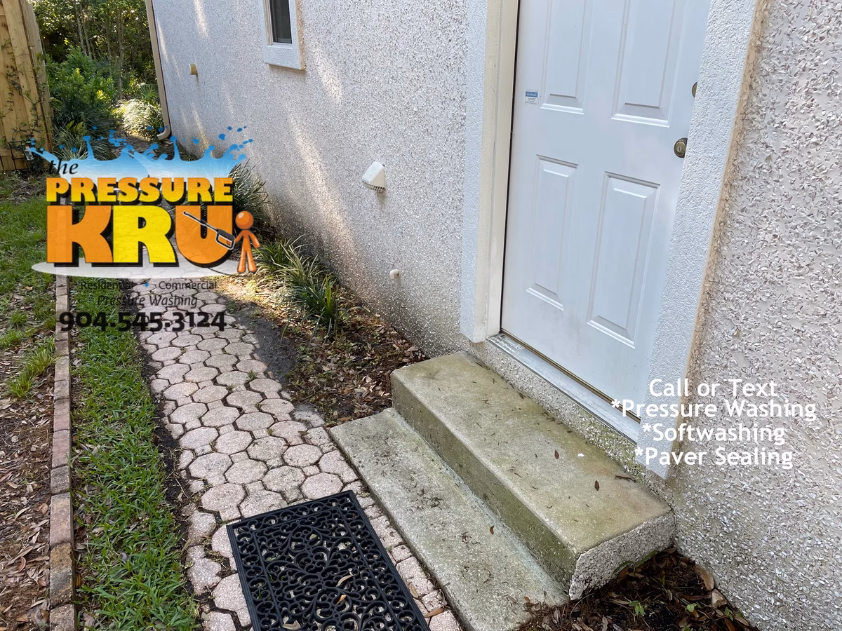 Soft wash coquina exterior in Sawgrass preserving natural stone finish. Image is before cleaning.