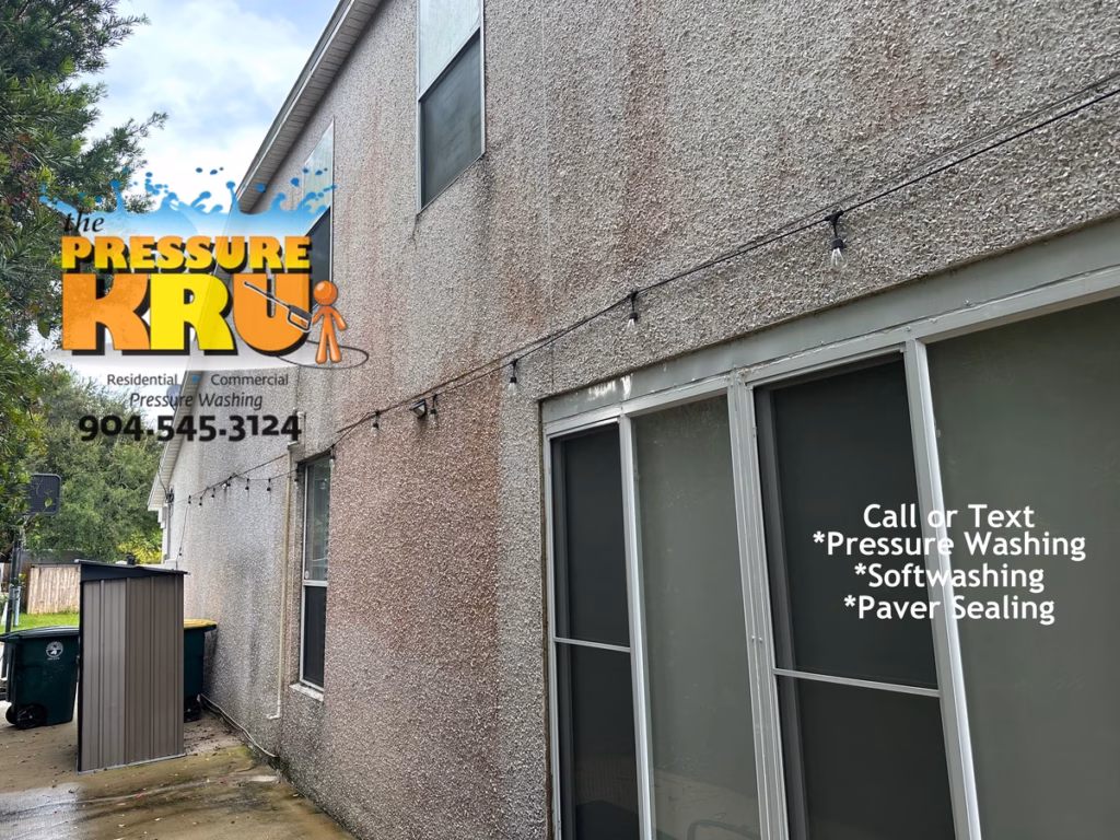 Soft wash coquina exterior in World Golf Village preserving natural stone finish. Before removing mildew and organic growth.