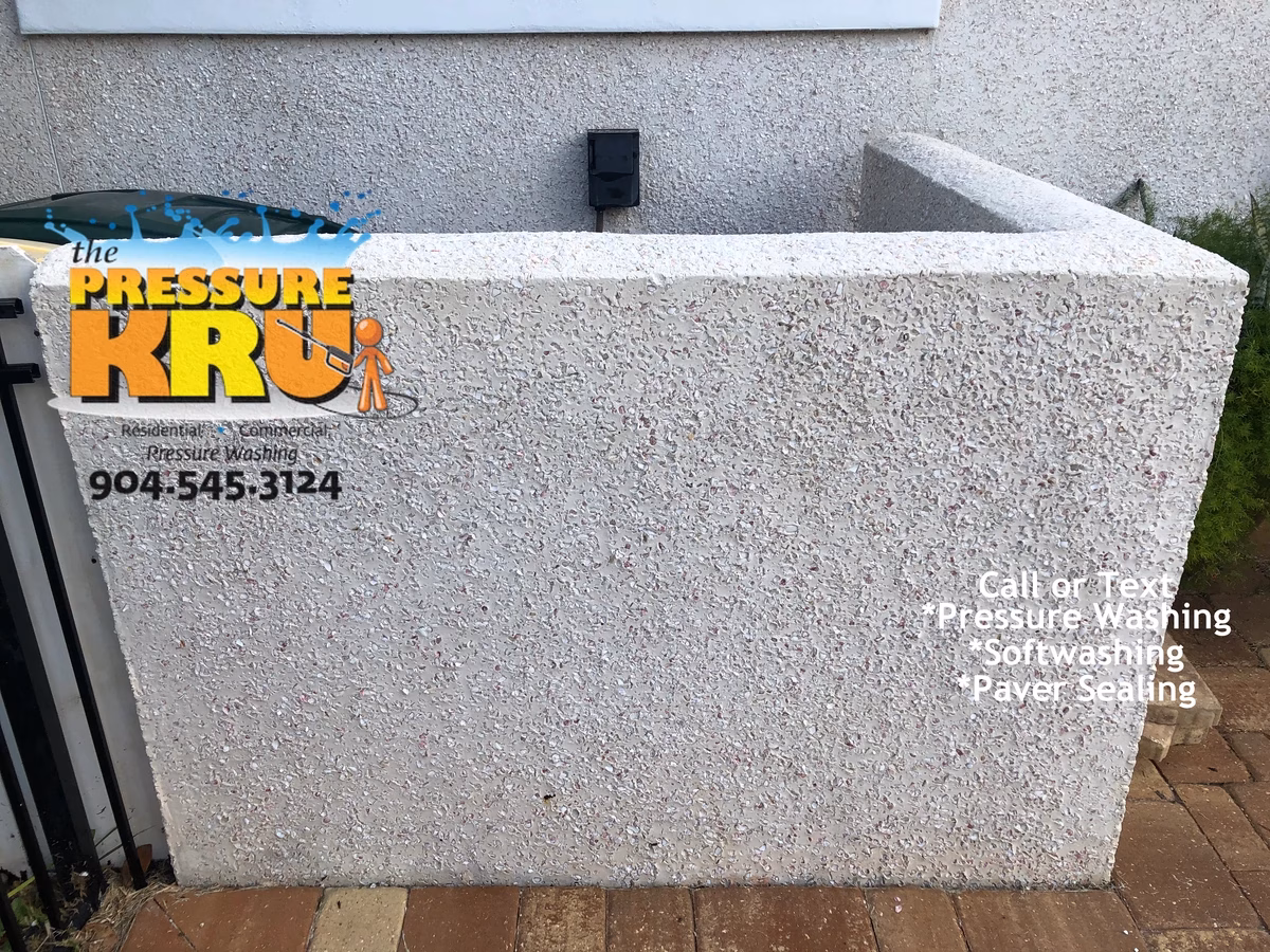 Exterior coquina soft washing in Fairway Village protecting stone from pressure damage. After picture showing only 1 year of algae growth removed.