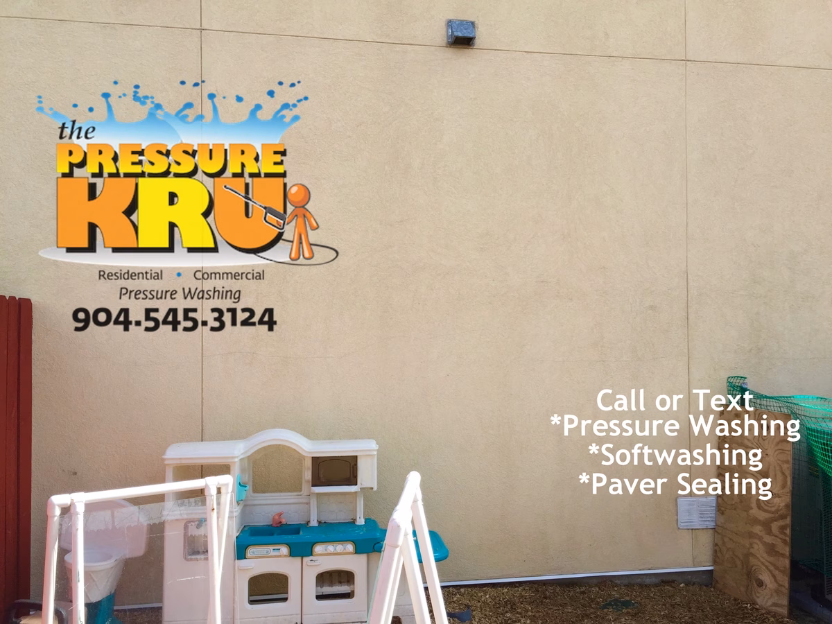 Stucco daycare building receiving professional soft washing treatment in St Johns FL after cleaning.