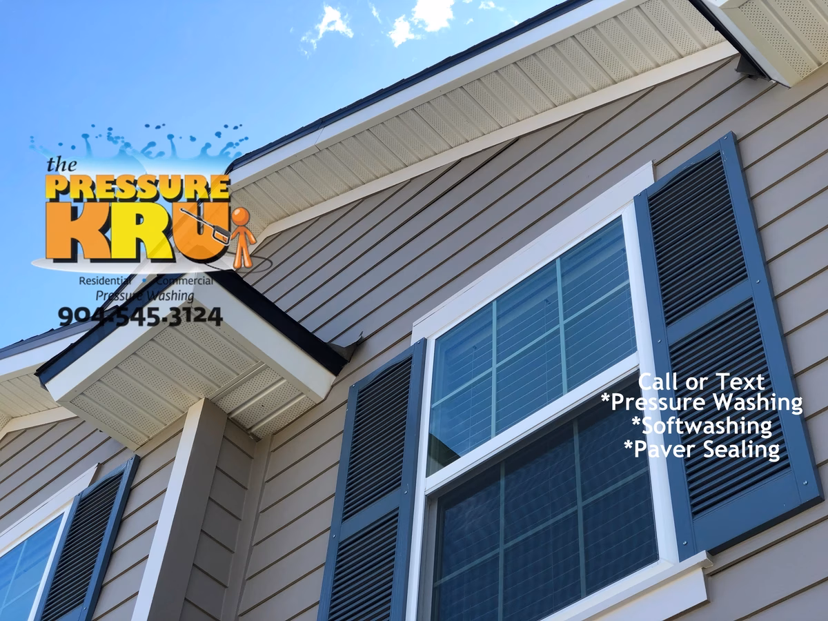 Soft washing home exterior in Julington Creek neighborhood removing algae.