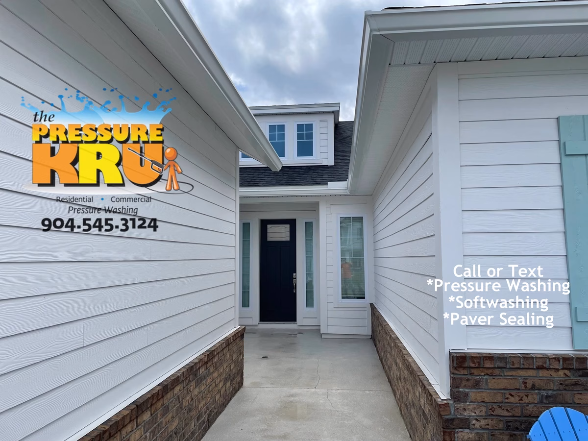 Professional house washing removes algae from siding and concrete in Rivertown neighborhood.