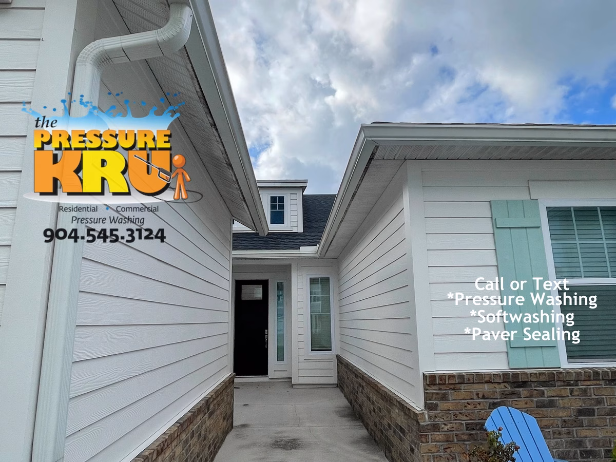 Professional house washing removes algae from siding and concrete in Rivertown neighborhood.