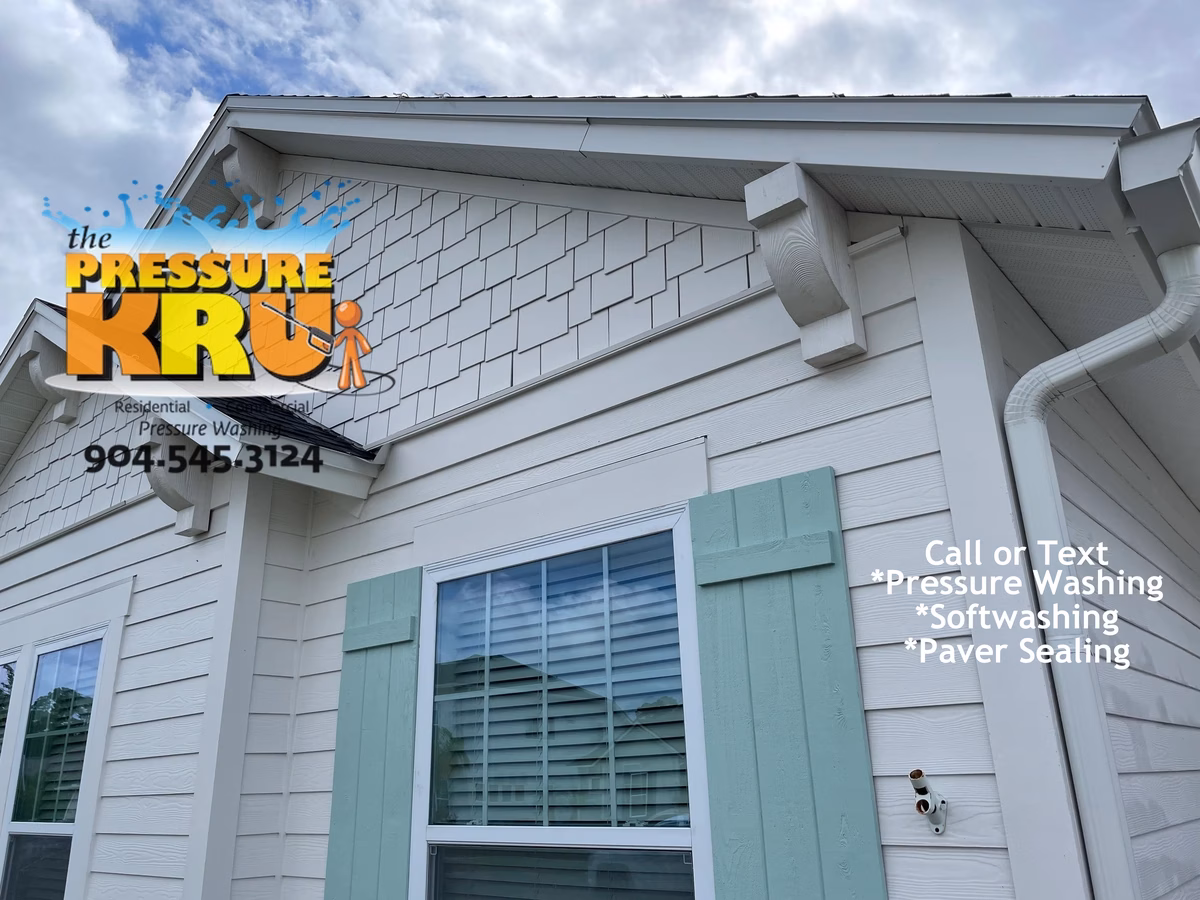 Professional house washing removes algae from siding and concrete in Rivertown neighborhood.
