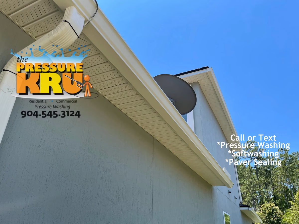 Clean white trim on stucco home in St Johns forest after professional soft washing.