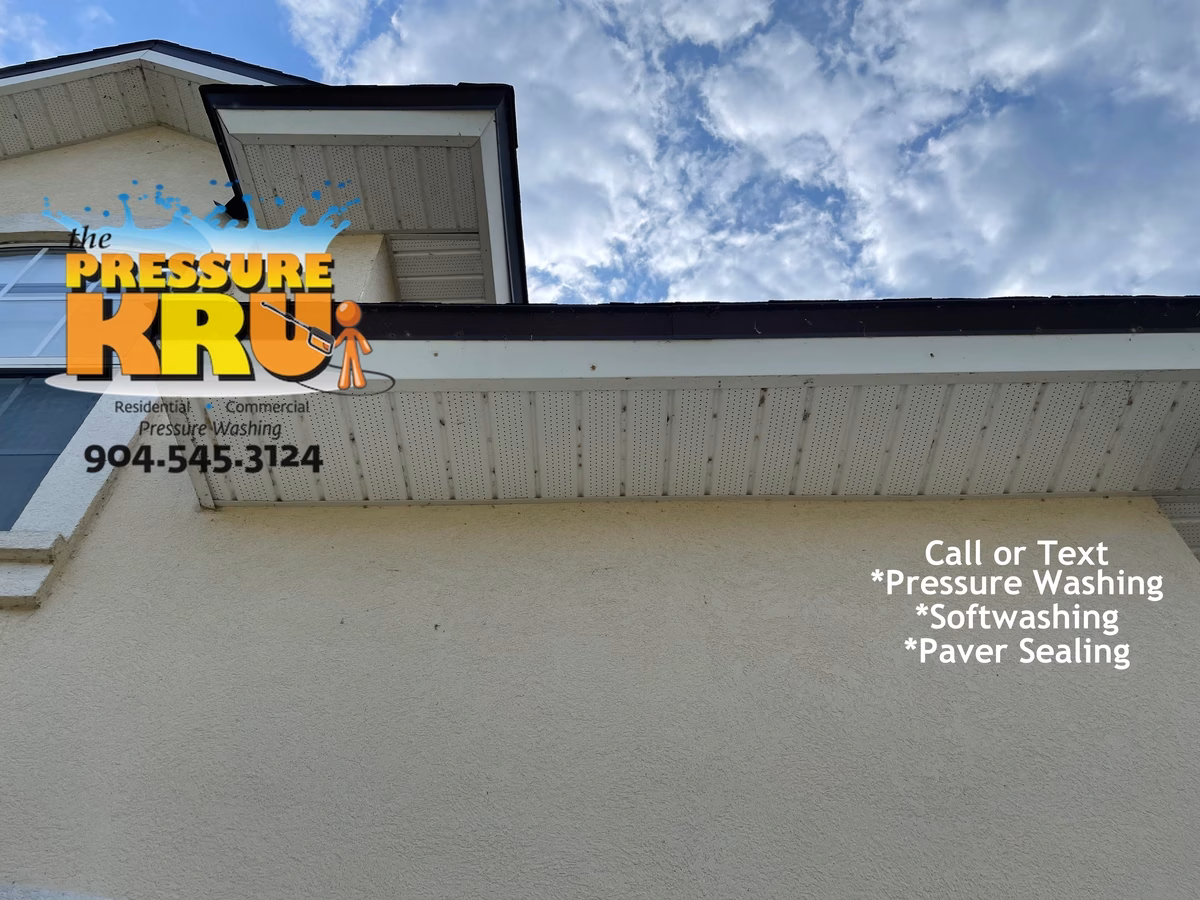 Exterior house washing service improves the appearance on stucco home while removing bug nests in Plantation Estates before cleaning.
