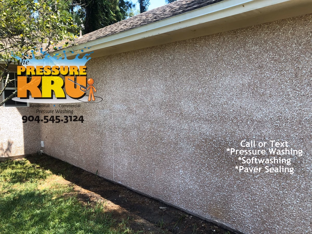 Pressure washing coquina siding in Julington Creek Plantation after. Image shows coquina still wet but dries out perfectly