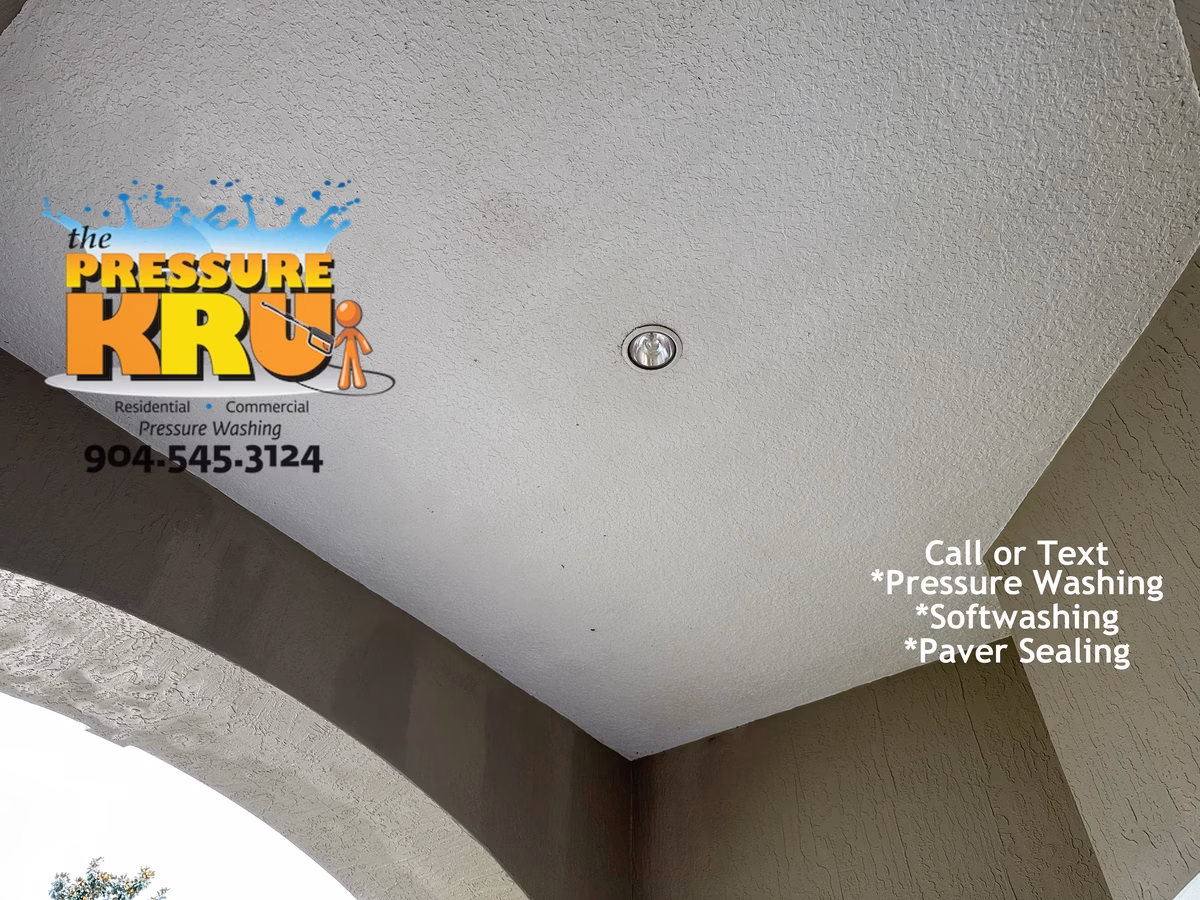 Safe low-pressure stucco house washing after chemical application in Julington Creek neighborhood.