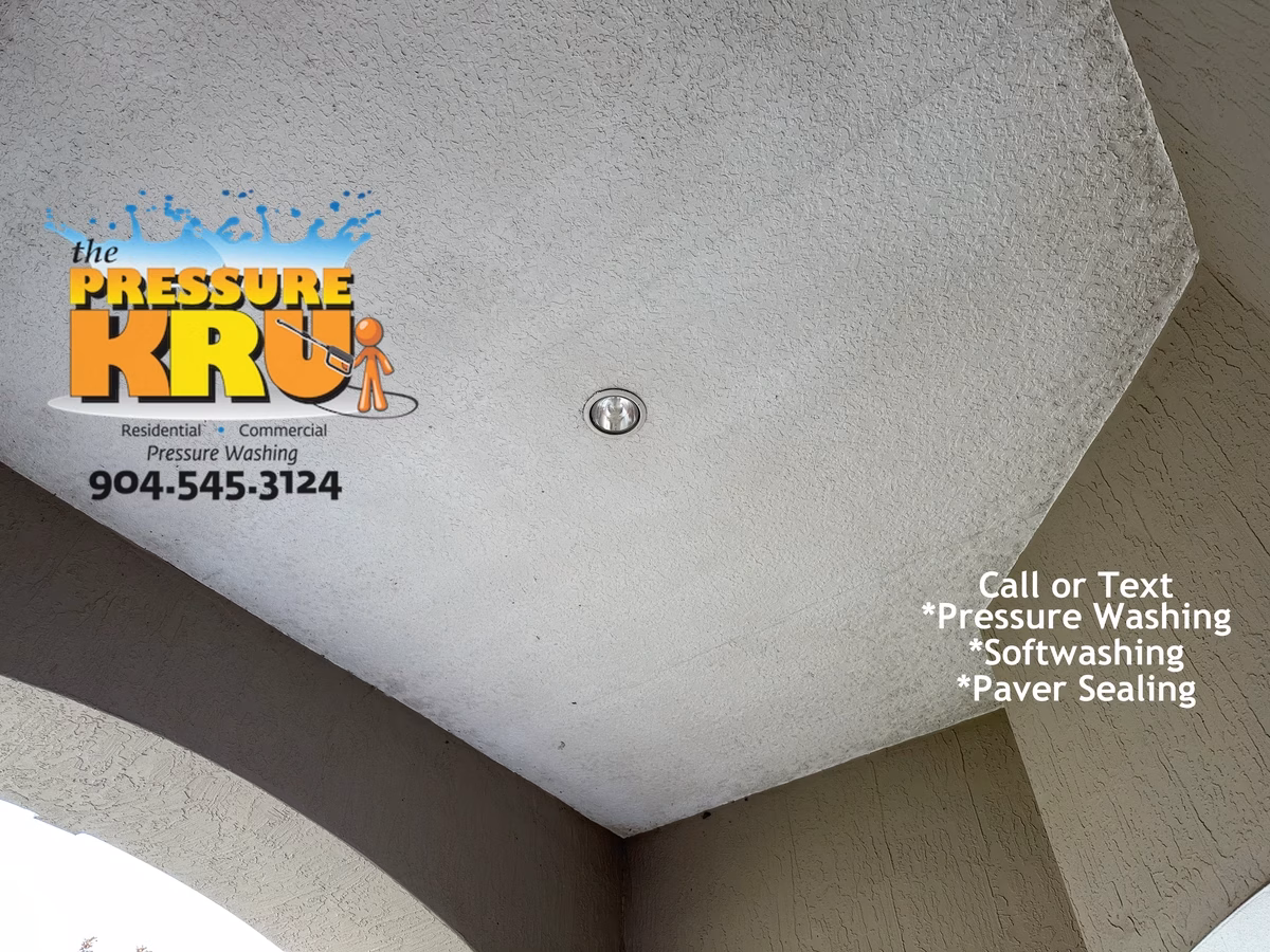 Safe low-pressure stucco house washing before chemical application in Julington Creek neighborhood.