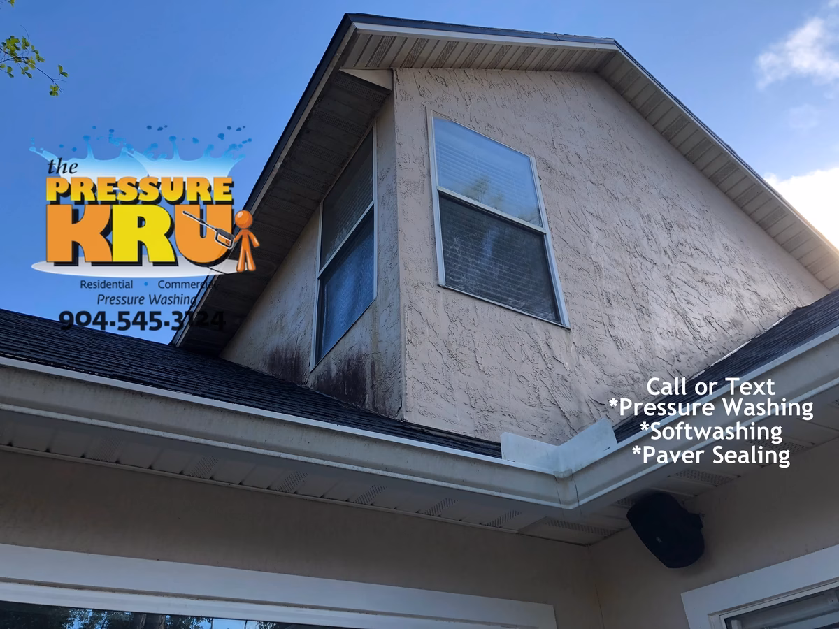 Two-Story Residential exterior before soft washing service for stucco home in Jacksonville FL.