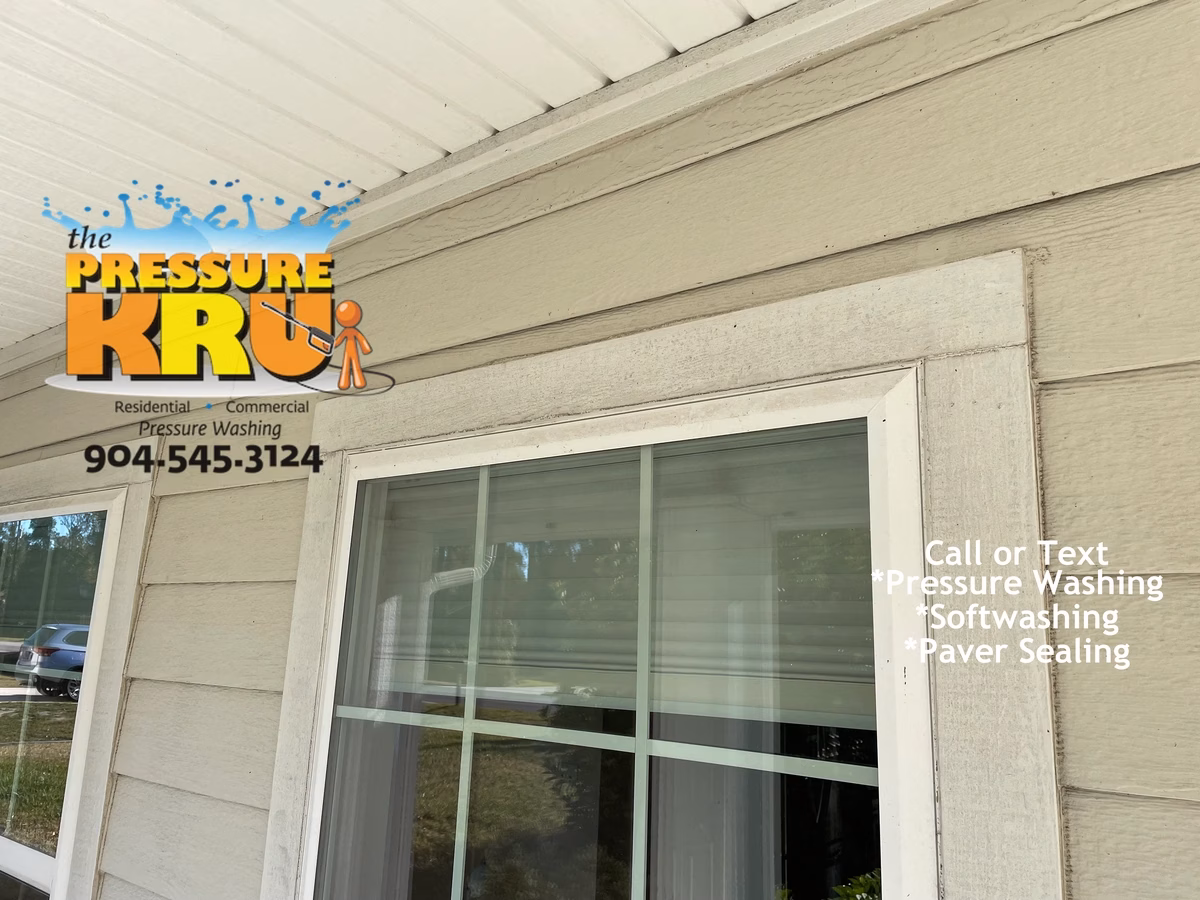 Softwashing home exterior in Julington Creek Neighborhood showing years of organic growth.
