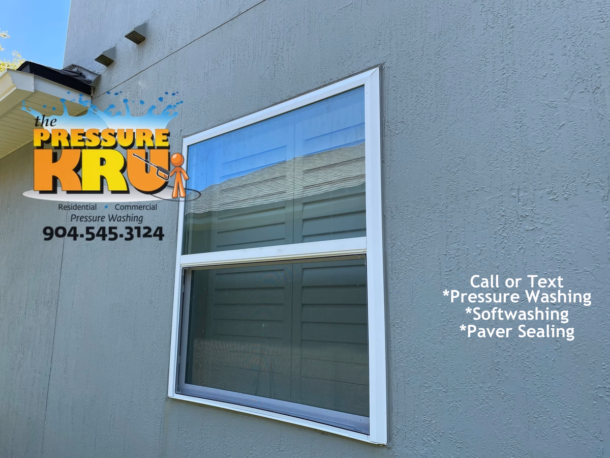 Residential exterior soft washing service for stucco home in Julington Creek Plantation Gentel on windows after.