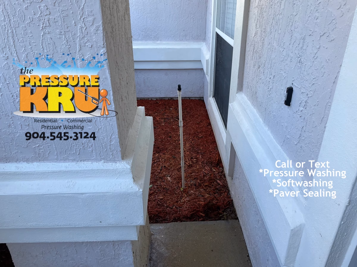 Soft washing stucco home to remove mold and mildew in Julington Creek neighborhood.