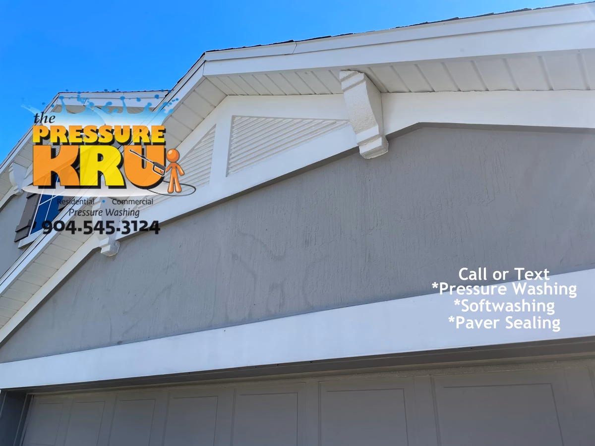 Stucco house washing service removing algae from a home in Bartram Springs neighborhood after.