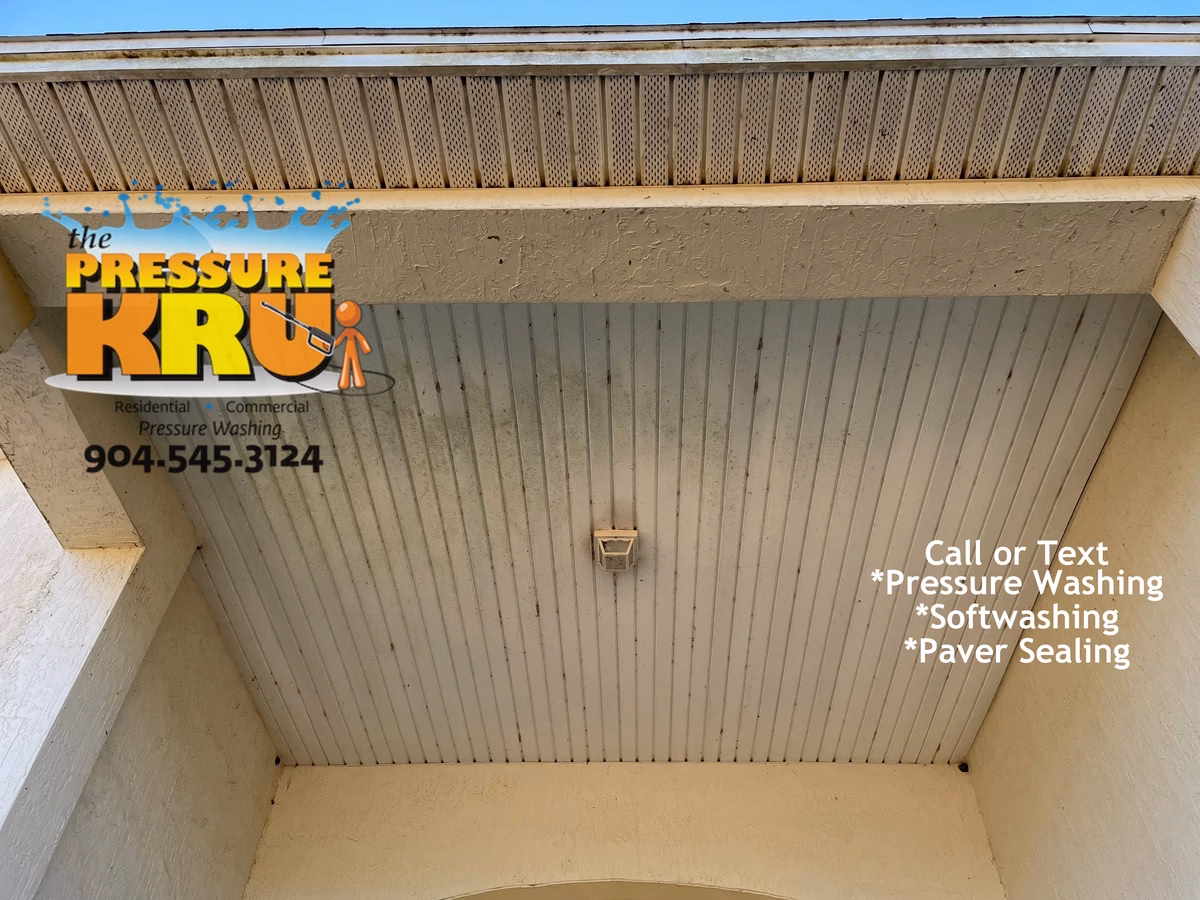 Two-story before soft washing service cleaning dirty stucco walls and soffits in World Golf Village.