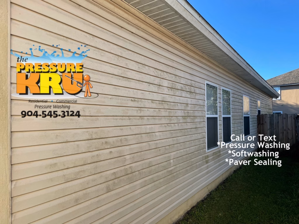 Professional vinyl siding house washing before soft washing in Julington Creek.