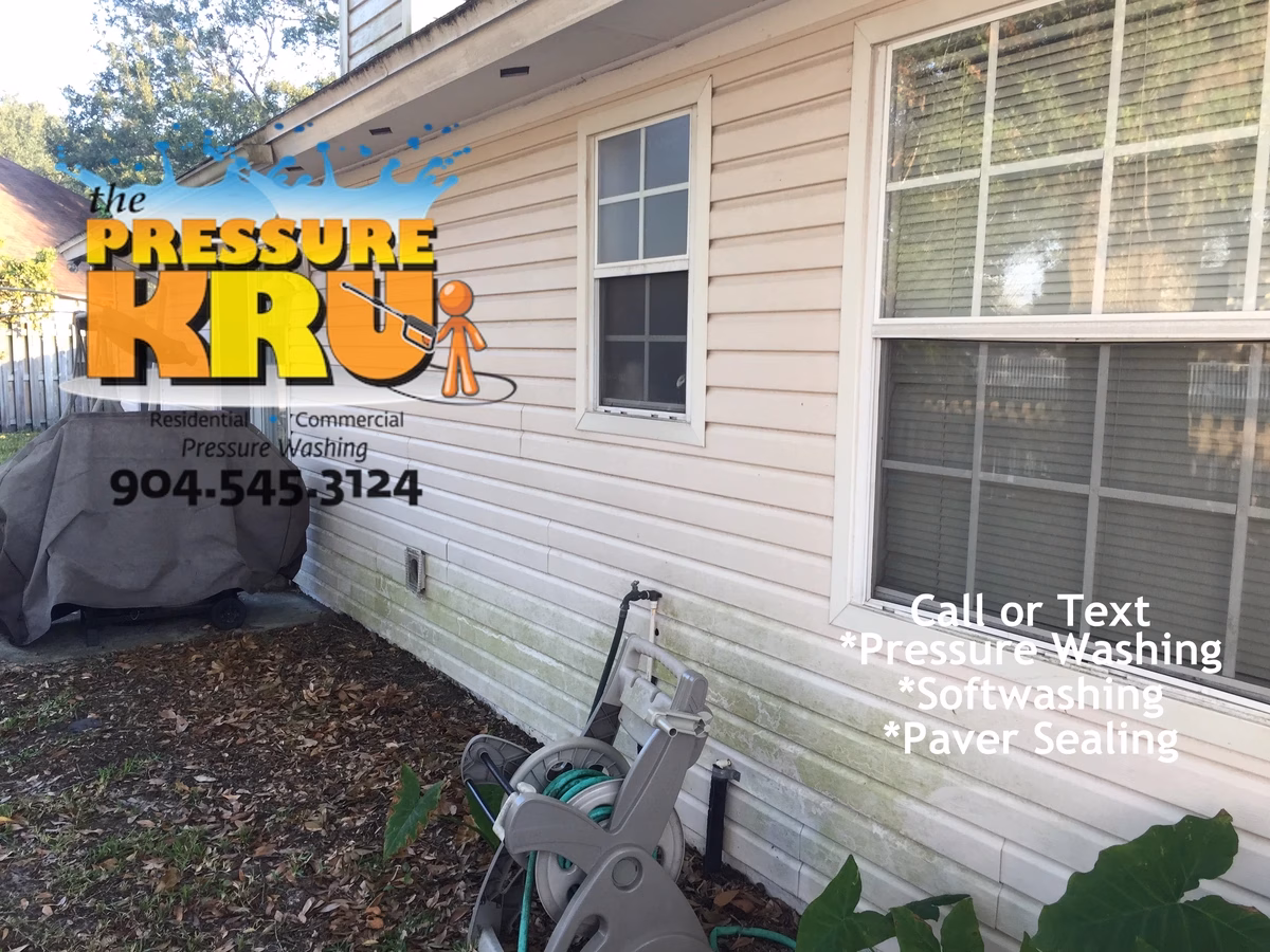 Vinyl siding before cleaning home in The Springs at Sandy Creek removing green algae stains