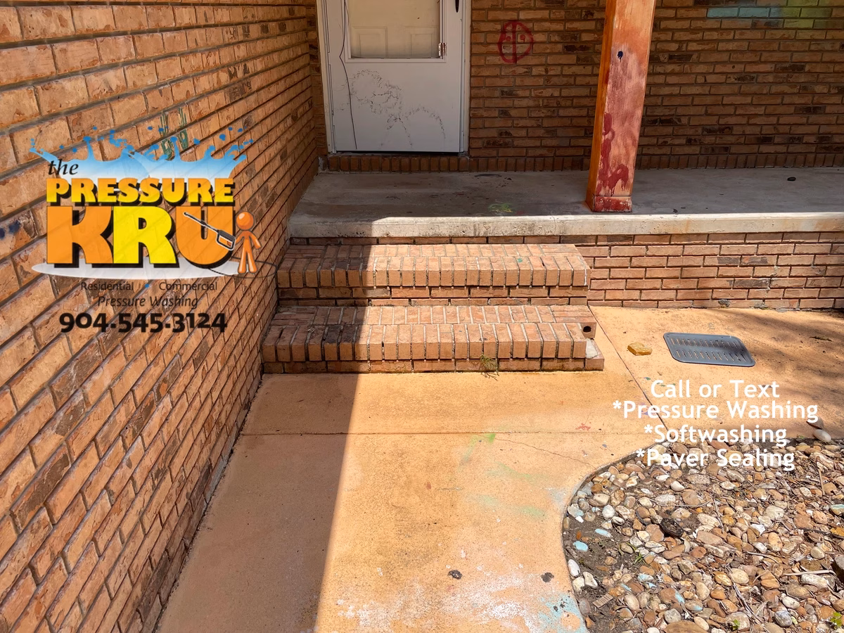 Brick home exterior cleaning before low-pressure softwash cleaning in Fruit Cove FL. Extreme algae and mildew growth on exterior Brick Walls, & Brick Steps