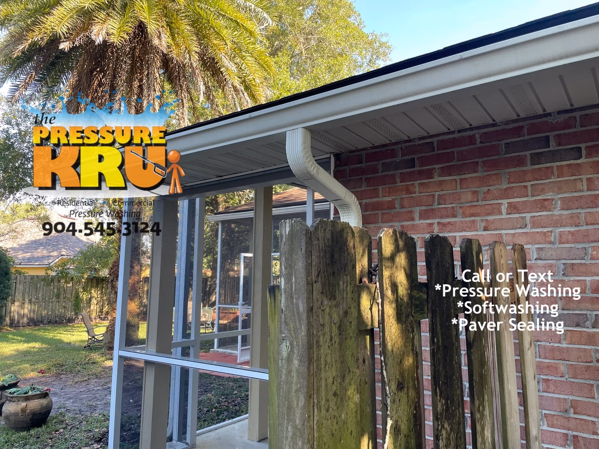 Brick house exterior soft washing service showing mold and mildew on gutter, siding and trim after cleaning in St Johns FL