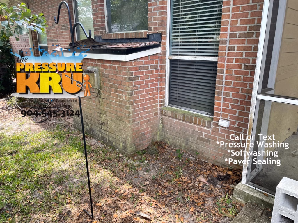 Exterior brick home before cleaning performed by softwashing expert in St Johns FL