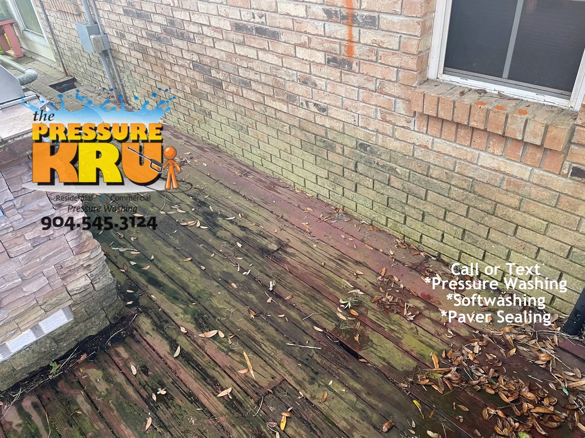 Brick exterior softwashing service before picture on luxury home in Jacksonville FL with heavy green algae
