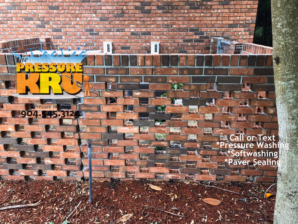 Brick home soft washing service after removing green algae and mold in St. Johns Florida.