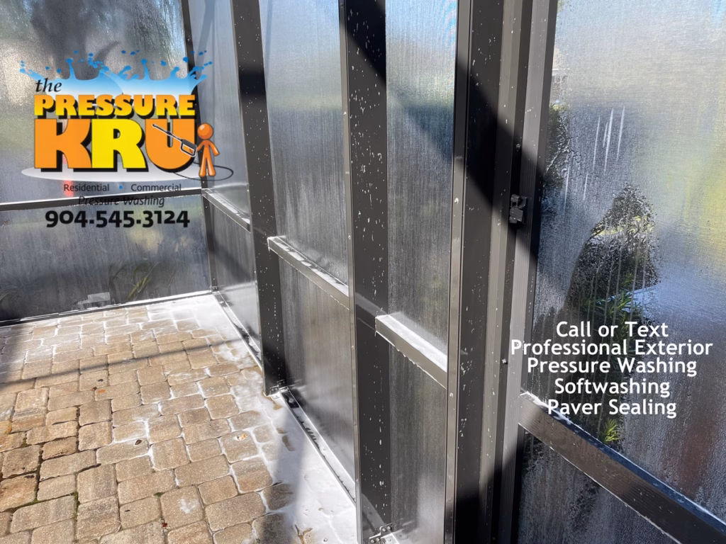 Screen Enclosure during soft washing in St. Johns, FL.