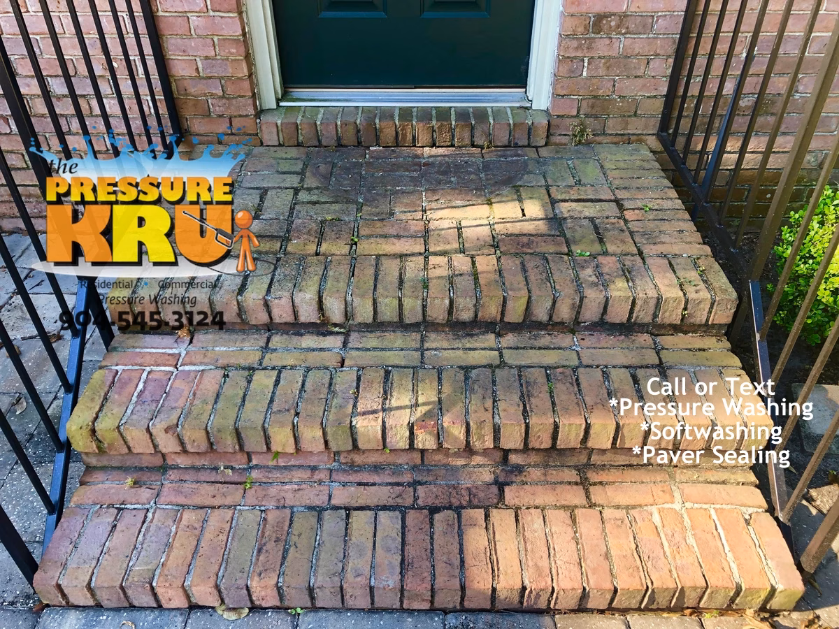 Professional brick exterior cleaning before removing algae and mildew from a home in World Golf Village