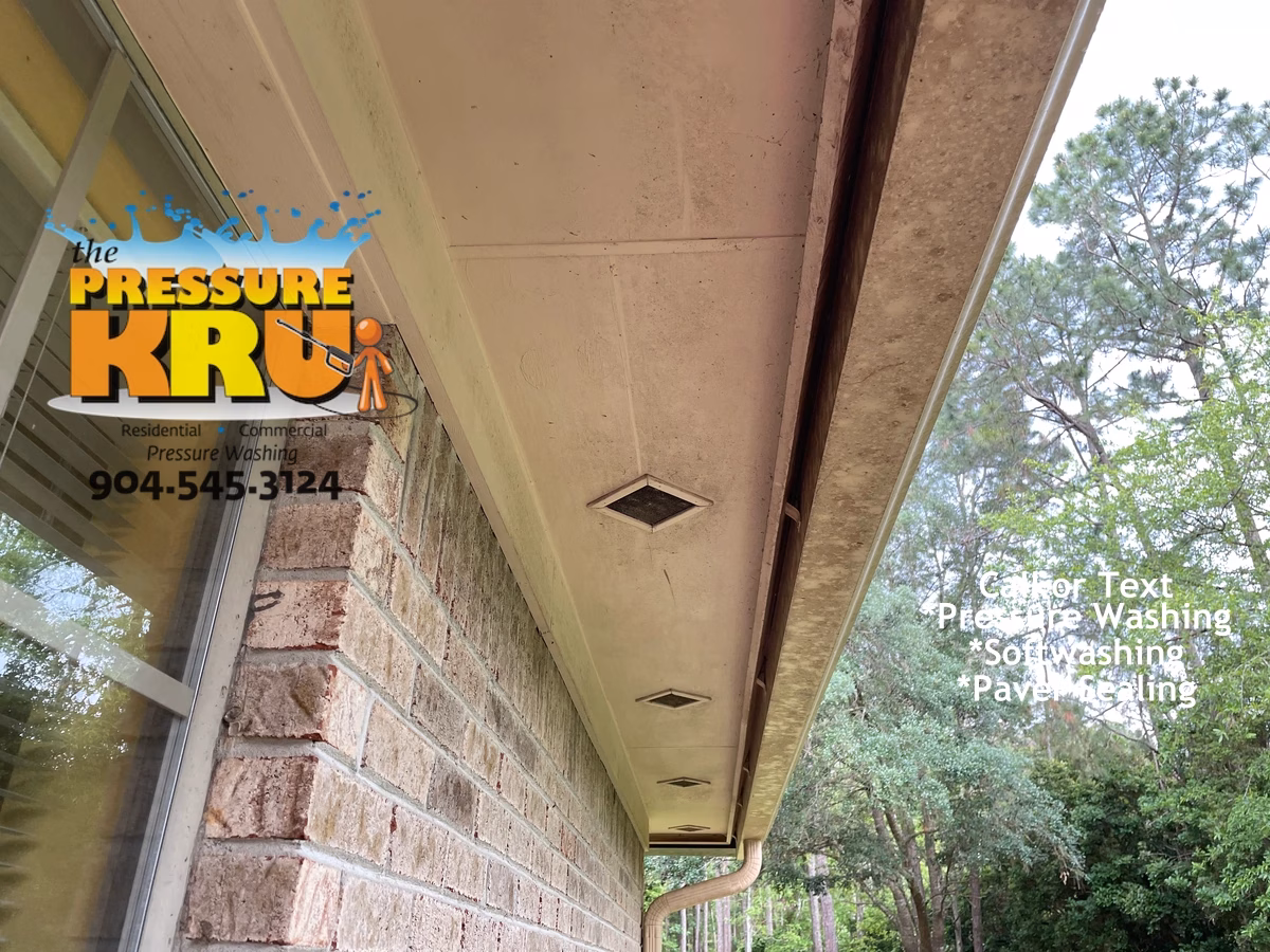 Before Soft washing brick exterior of a home cleaning soffits and gutters of Jacksonville FL.