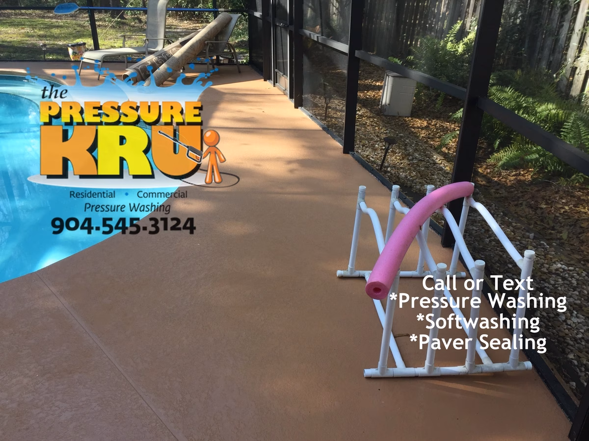 Soft washing painted pool deck and screen enclosure in St Johns Golf and Country Club after