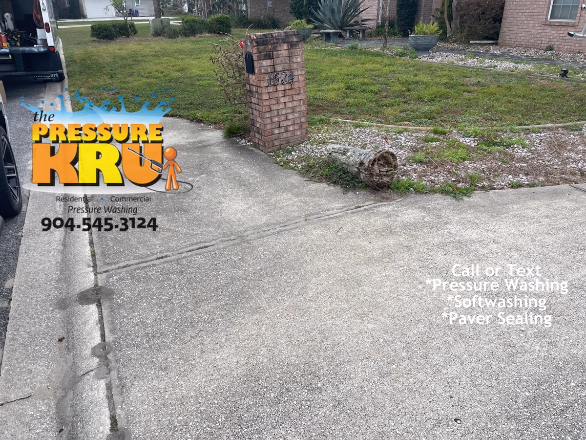 Local driveway cleaning company restoring curb appeal with soft washing technique in St. Johns, FL. Before picture.