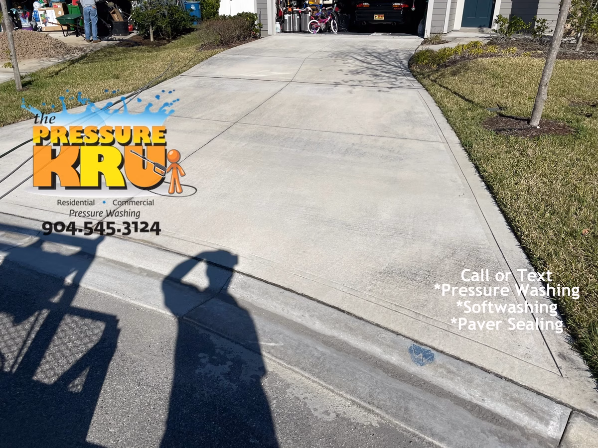 Professional pressure washing driveway before and after in St. Johns, FL. Before annual cleaning showing difference cleaning makes.