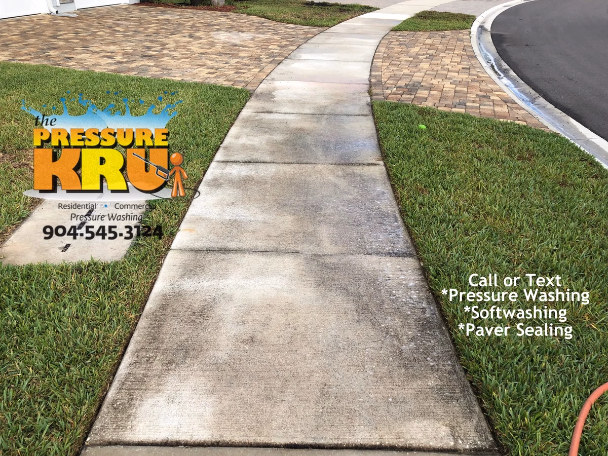 Restored sidewalk and driveway looking brand new after expert service in St. Augustine, FL. Before picture.
