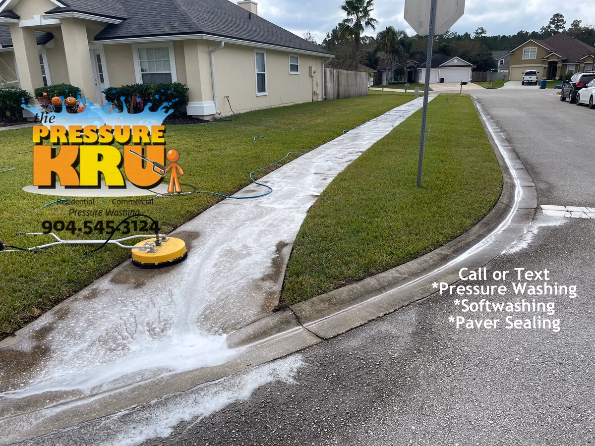 Before and after comparison of pressure washed concrete sidewalk and driveway in Fruit Cove, FL before pressure washing and soft washing.