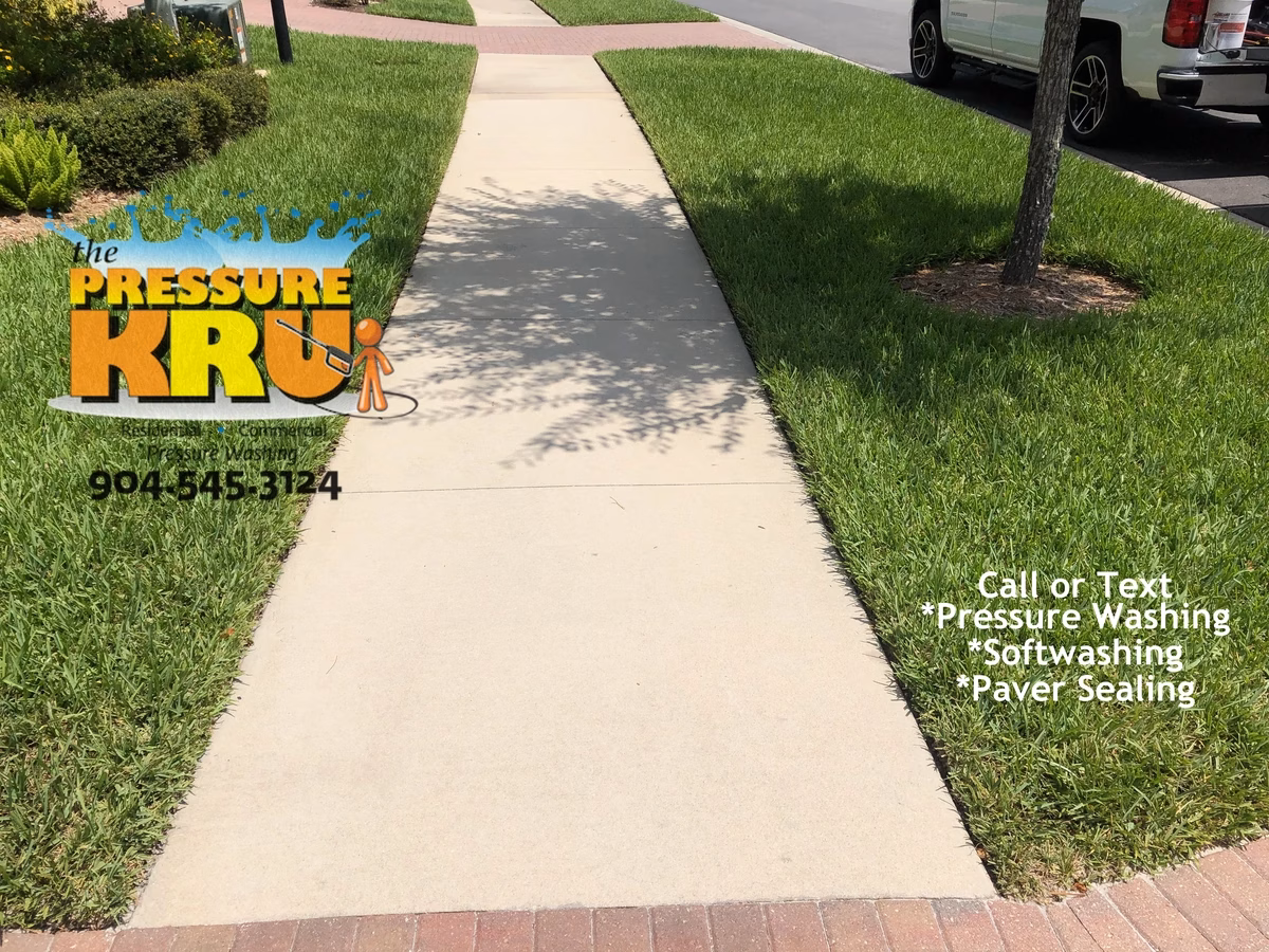 Clean and dry sidewalk and driveway after professional power washing session near St. Johns, FL. 32259. After image.