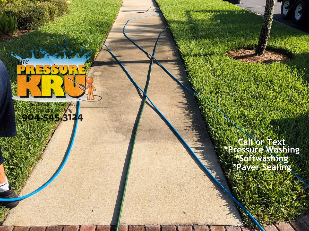 Clean and dry sidewalk and driveway after professional power washing session near St. Johns, FL. 32259. Before image.