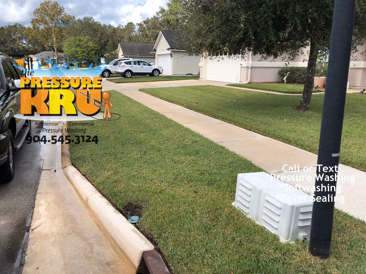 Detail power washing of concrete driveway and curb surfaces in St. Augustine, FL. Offered rust removal from curbing but owner declined. Could have completely removed this rust. After image.