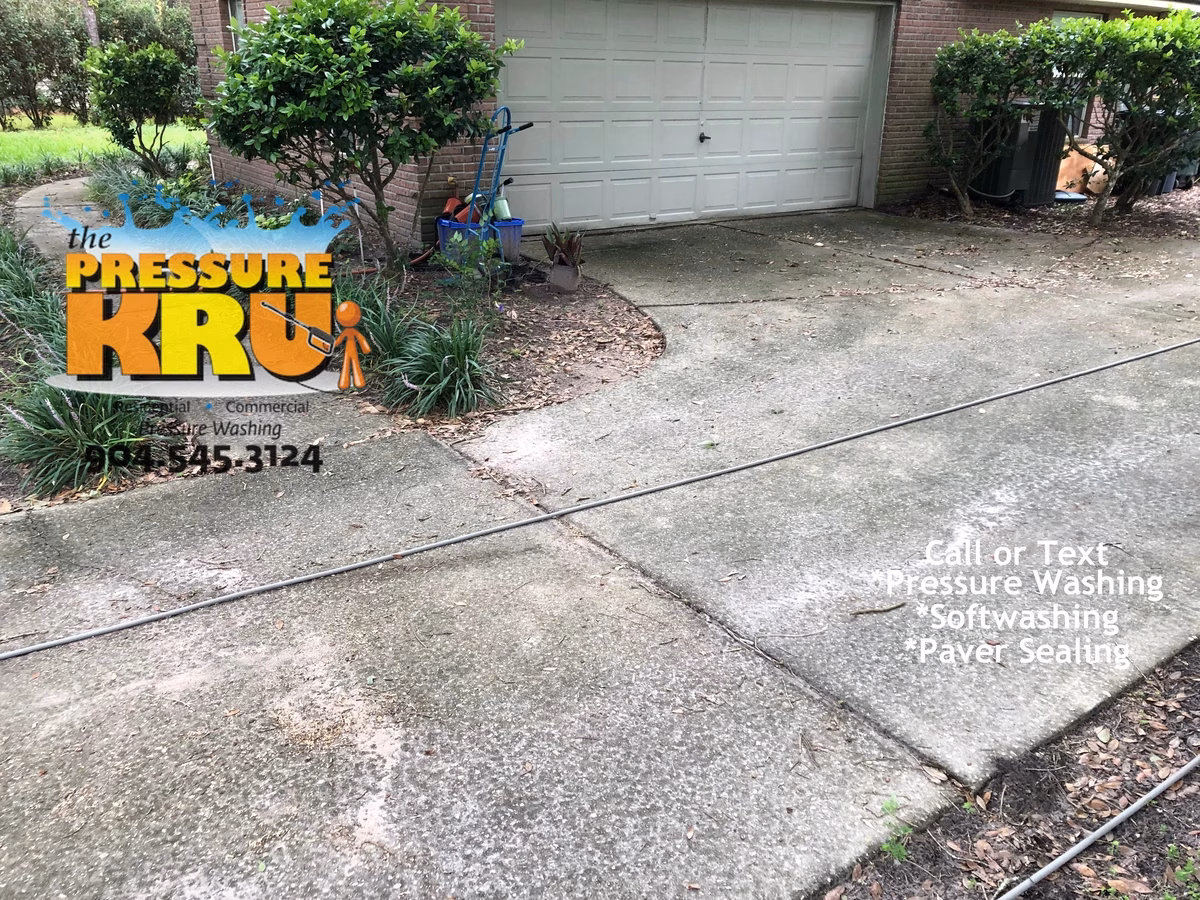 Expert team pressure washing residential driveway year-round near Windsor Park in Jacksonville, FL. Before cleaning service.