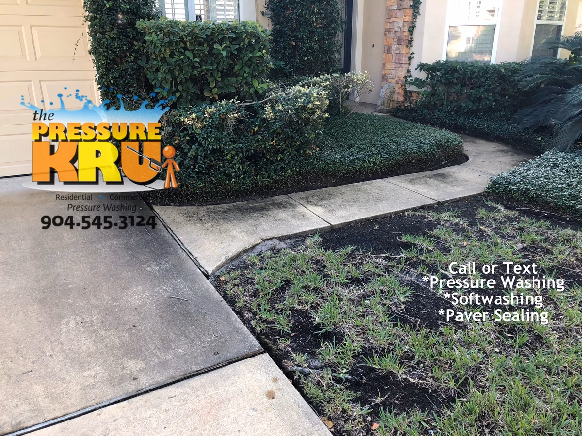 Professional concrete driveway before cleaning boosting property value in St Johns, FL.