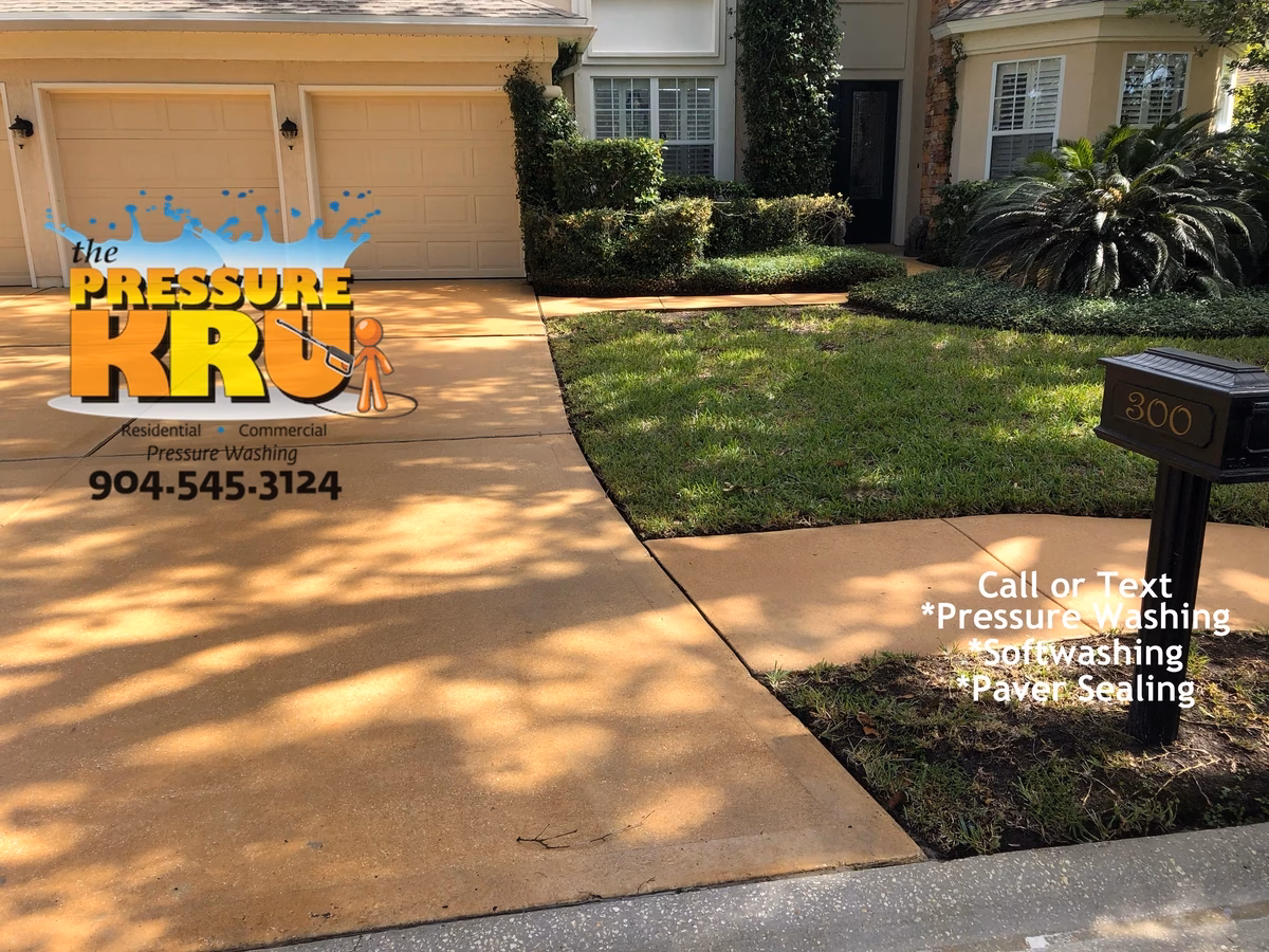 Power washing large two-car driveway in suburban St Johns County after starting work.