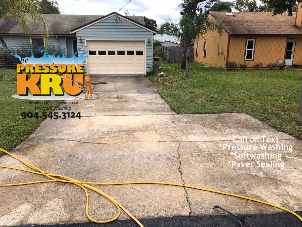 Beautifully cleaned non-draining concrete driveway in St Johns FL. Before starting this was horrible draining situation.