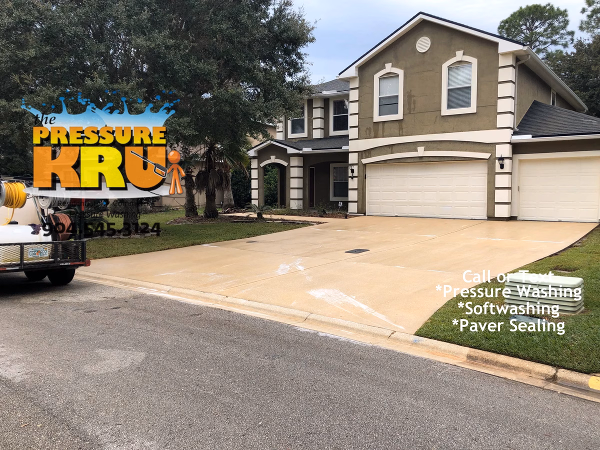 Rust Stain removal from this concrete driveway using targeted pressure wash in St Johns FL after service.