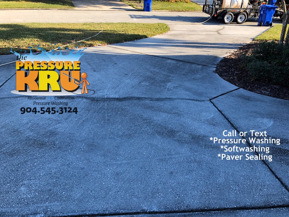 Concrete driveway power washing removing fall and winter grime in St Johns FL before cleaning.