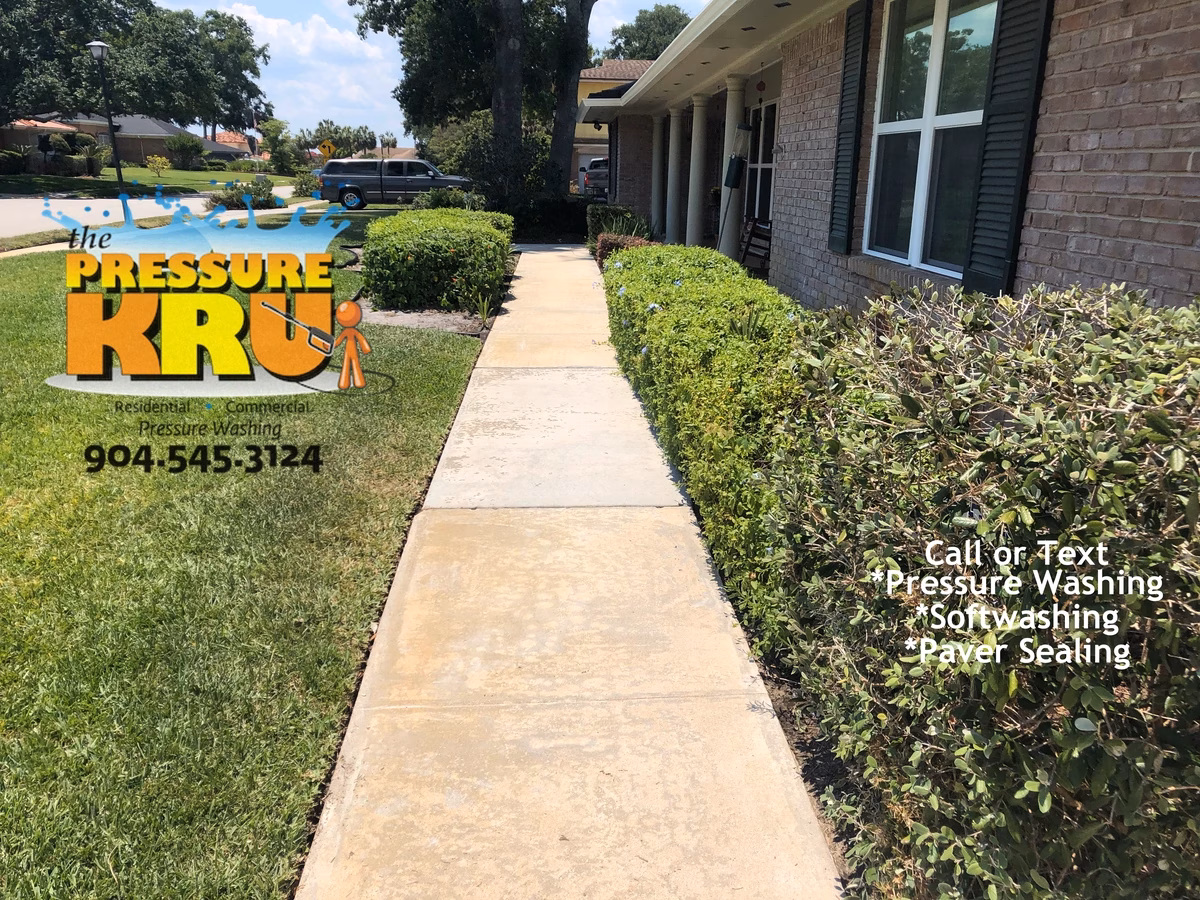 Sidewalk and driveway professional power washing restoring clean appearance in St. johns, FL. This is a after cleaning.