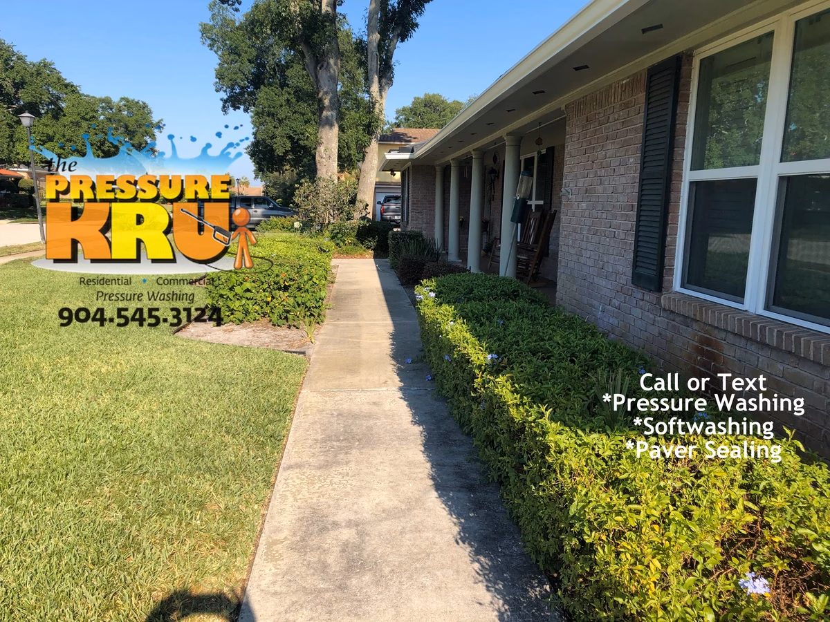 Sidewalk and driveway professional power washing restoring clean appearance in St. johns, FL. This is a before image.