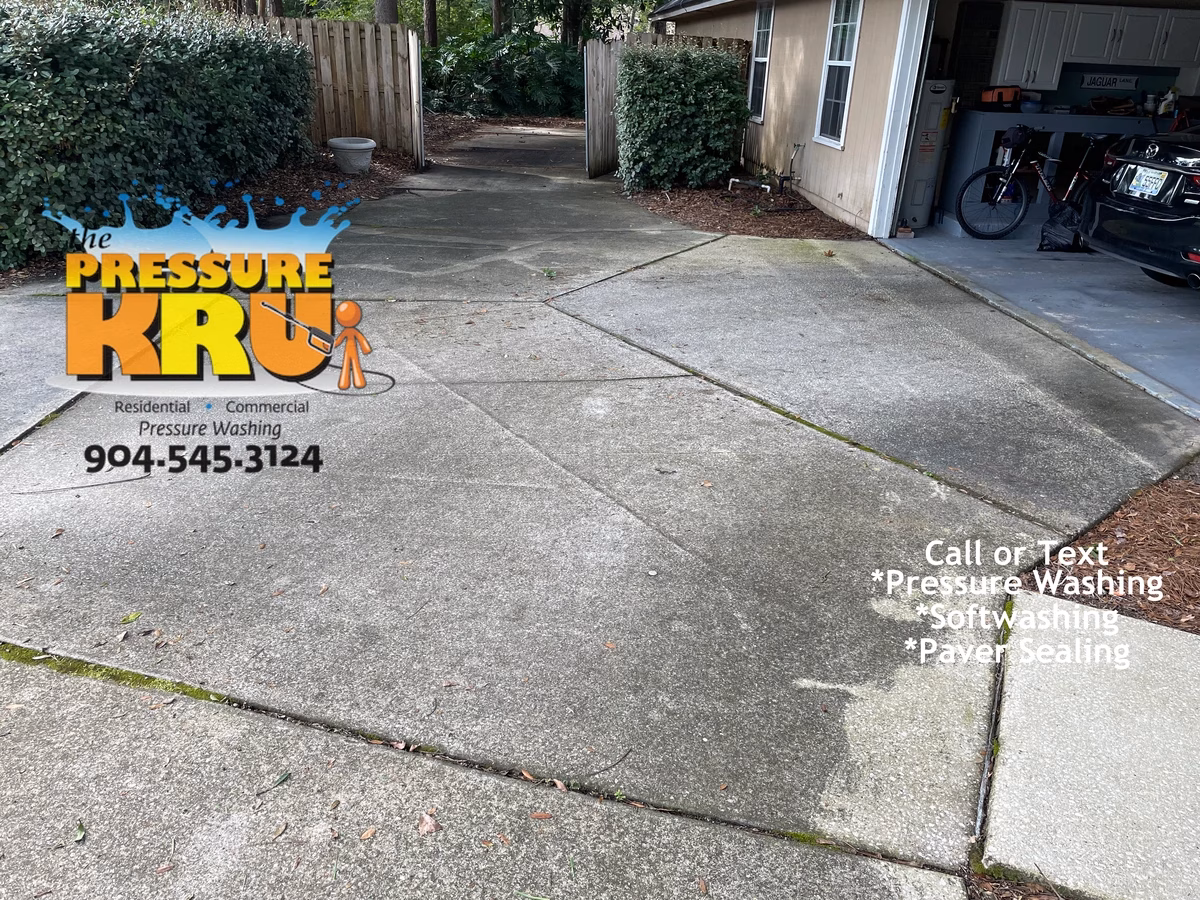 Professional power washing restoring faded driveway color in Jacksonville, Florida before cleaning.